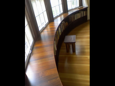 A curved bookcase built to match the curved of the existing house, top is made of Ipe wedges and the rest is solid walnut